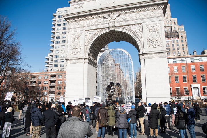 People take part in a prayer and protest at Washington Square Park to mark the anniversary of Trump's first travel ban.