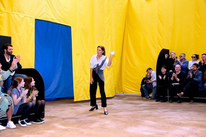 British fashion designer Phoebe Philo waves to the audience at the end of the Céline show during Paris Fashion Week during October 2015. 