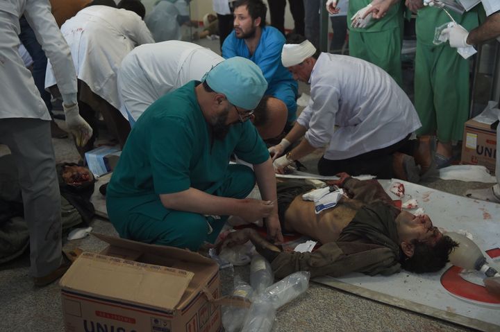 Afghan medical staff treat a wounded man