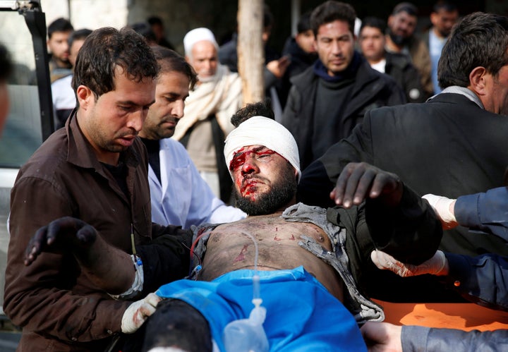 An injured man receives medical assistance after a blast in Kabul, Afghanistan on January 27, 2018. 