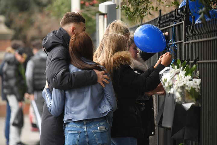 People laid tributes at the scene on Shepiston Lane in Hayes on Saturday