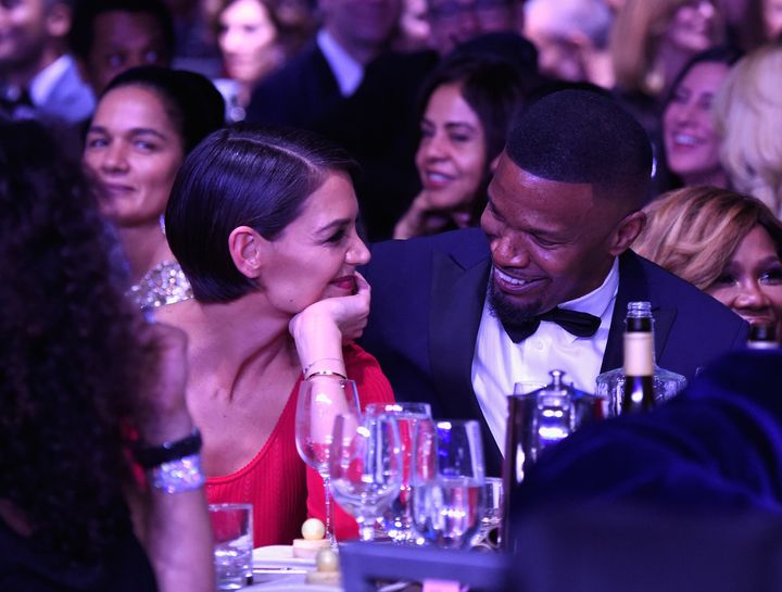 Katie Holmes and Jamie Foxx smile at each other at a pre-Grammy Awards event on Saturday night.
