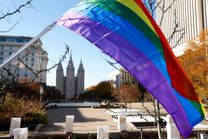 A pride flag flies in front of the Salt Lake Temple of The Church of Jesus Christ of Latter-day Saints in Utah.