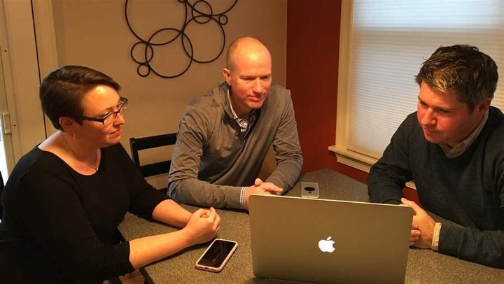 Sara Stovall, Karl Quist and Ian Dixon at Stovall’s kitchen table in Charlottesville, Virginia. On behalf of 700 other residents, they’re gathering data to convince state regulators that the health insurance premiums in their community are unjustified.