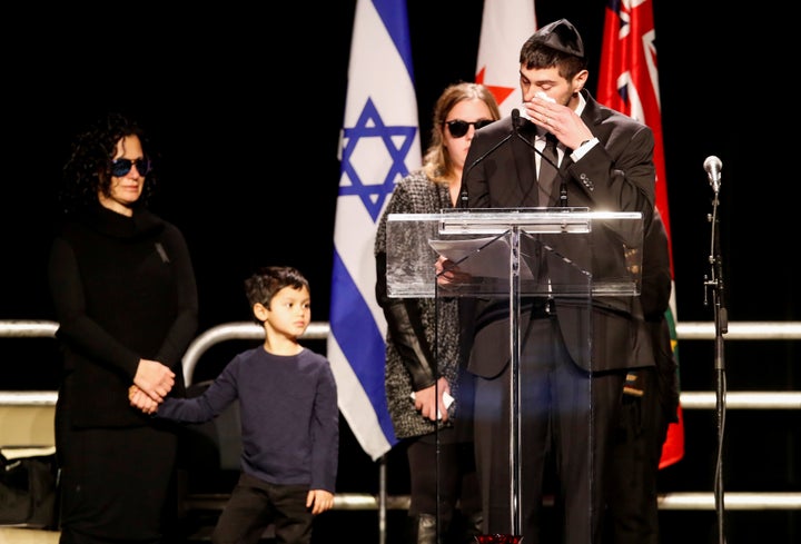 Jonathon Sherman speaks at a memorial service in front of other family members, about his parents, Barry and Honey Sherman.