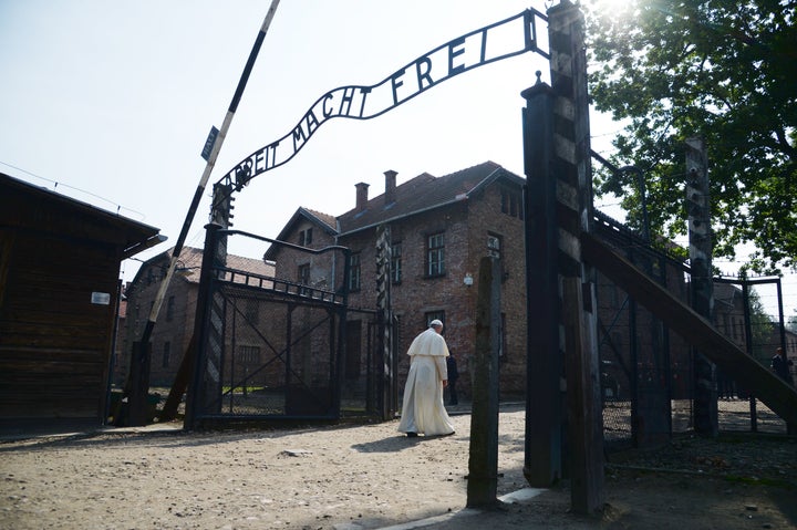 Pope Francis passes the main entrance of the former Nazi German Auschwitz-Birkenau death camp on July 29, 2016, as part of a visit to Poland.