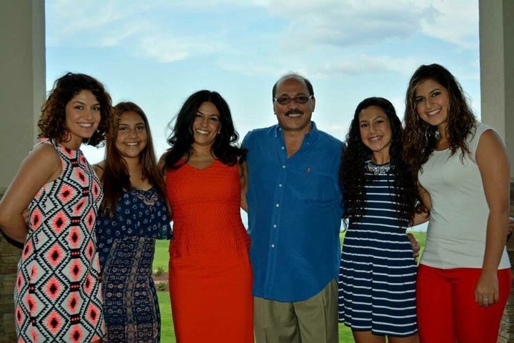 Amer Othman Adi, fourth from left, with his wife and daughers.