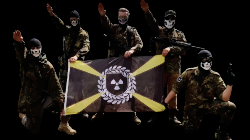 Members of the Atomwaffen Division, a violent neo-Nazi group, pose with their nuclear-themed flag. 