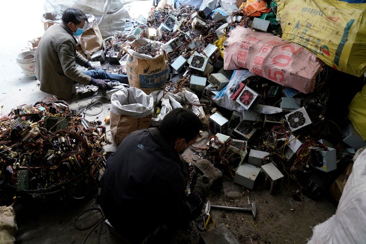 Workers dismantle electronic waste in Guiyu, Guangdong Province, China.