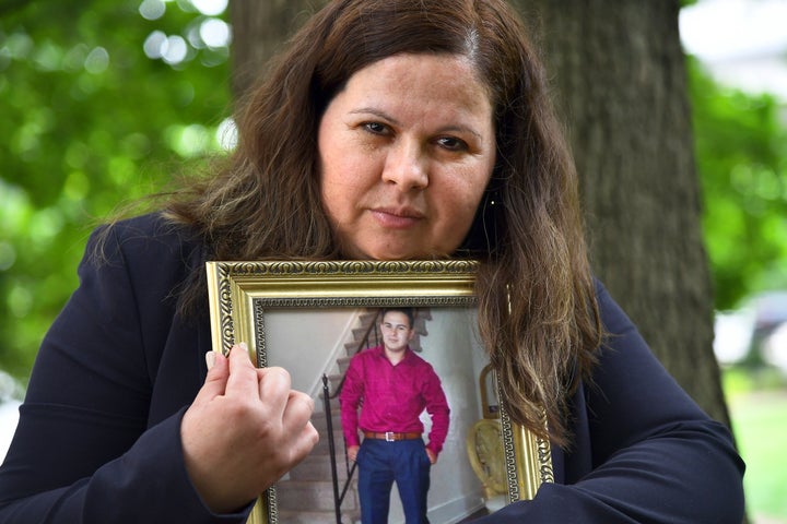 Bertha Morales holds a photograph of her son, Christian Villagran-Morales, who was murdered by members of the MS-13 gang in 2016.