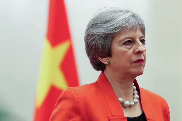Theresa May is in China on a trade mission while parliament debates Brexit at home.