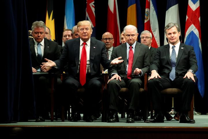 President Donald Trump onstage with Attorney General Jeff Sessions and FBI Director Christopher Wray as he participates in a graduation ceremony at the FBI Academy in Quantico, Virginia, on Dec. 15, 2017.
