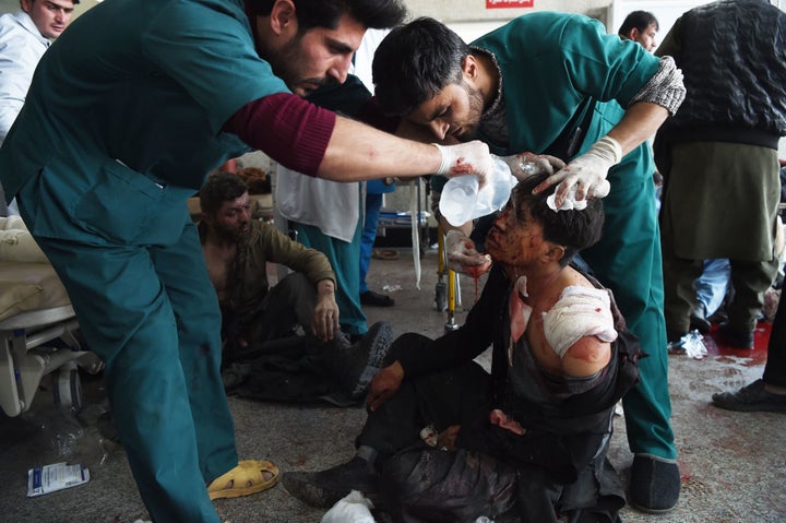 Afghan medical staff treat a wounded man after a car bomb in Kabul on Jan. 27.