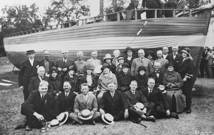 Descendants of Norwegian immigrants pose at the Minnesota State Fairgrounds by the sloop on which their ancestors came to America in 1925. 