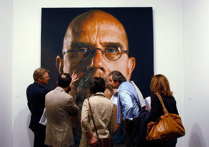 An art tour group studies a painting by Chuck Close at Art Basel Miami Beach in 2008.