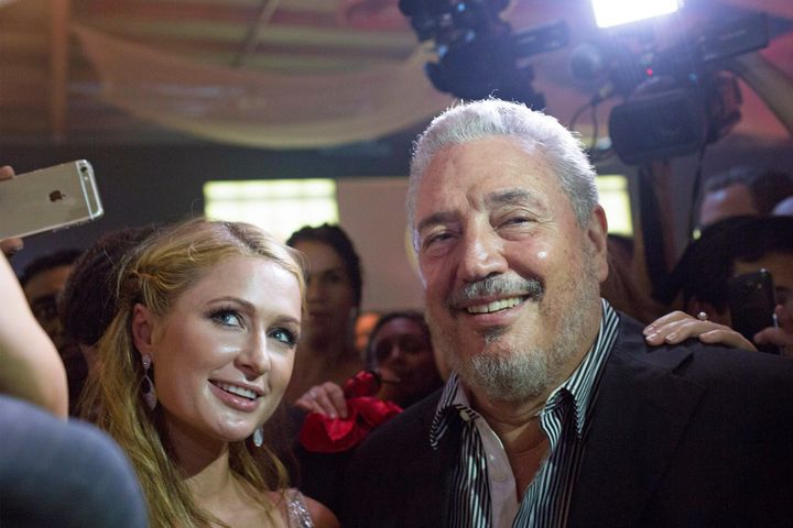 Diaz-Balar poses with Paris Hilton as she takes a selfie during the gala dinner of the closing of the XVII Habanos Festival, in Havana, February 2015