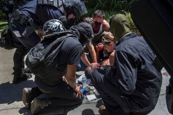 A stabbing victim is attended to during a neo-Nazi rally in Sacramento, Calif., June 26, 2016.