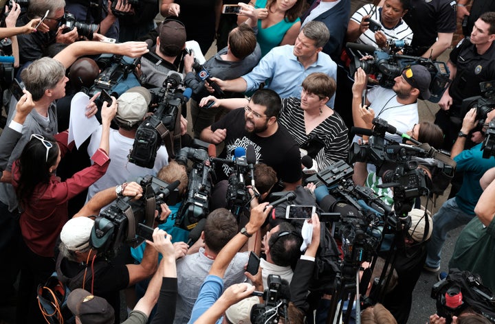 White nationalist leader Matthew Heimbach (C) screams at the media in defense of James Alex Fields Jr. outside of Fields bail hearing on charges of suspicion of murder, malicious wounding and hit-and-run charges ensuing from Fields arrest after a car hit counter protesters at the "Unite the Right" rally in Charlottesville, Virginia, August 14, 2017.