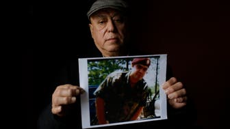 Miguel Perez poses as he holds a photo of his son Miguel Perez Jr., on April 4, 2017 in Chicago, Illinois.
Perez Jr., an Army veteran is facing deportation after serving seven years in a state penitentiary on a drug charge. / AFP PHOTO / Joshua LOTT / TO GO WITH AFP STORY BY NOVA SAFO-'US military veterans deported after committing crimes'        (Photo credit should read JOSHUA LOTT/AFP/Getty Images)