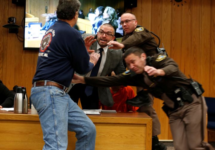 Randall Margraves, left, attempts to attack former USA Gymnastics doctor Larry Nassar (wearing orange) in court.