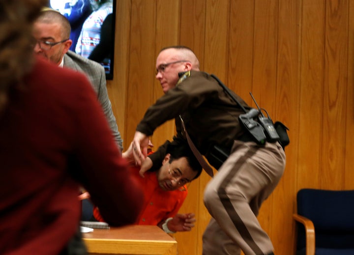 Nassar's attorney and a law enforcement officer deflect Margraves' attack.