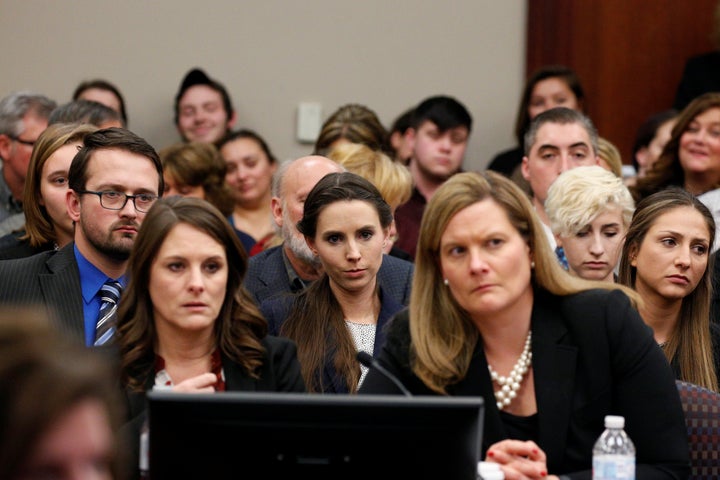 Rachael Denhollander (center) listens as Larry Nassar is sentenced.