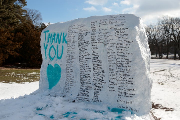 A boulder on the campus of Michigan State University is painted with the names of assault victims of Larry Nassar.