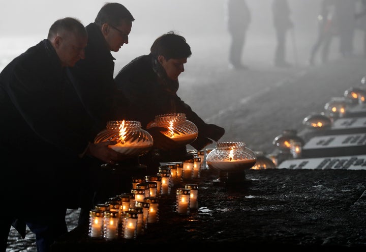 Polish politicians place candles during ceremonies marking the 73rd anniversary of the liberation of Auschwitz II-Birkenau, near Oswiecim, Poland, on Jan. 27, 2018.