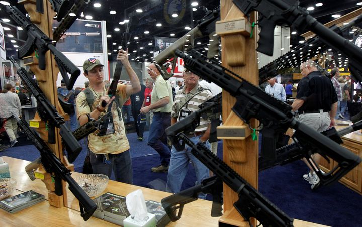 Gun enthusiasts look over Rock River Arms' guns at the National Rifle Association's annual meetings and exhibits show in Louisville, Kentucky, on May 21, 2016. 