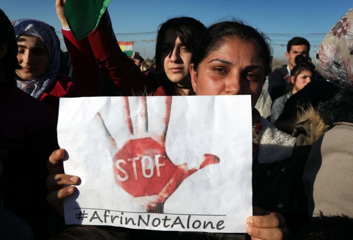 Syrian Kurds wave the Kurdish flag and flags bearing the logos of the People's Protection Units and Women's Protection Units as they chant slogans in the northern Iraqi city of Arbil, the capital of the autonomous Kurdistan region, during a demonstration on Feb. 2, against the military operation by the Turkish army against the Kurdish YPG forces in Syria's Afrin.