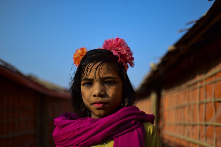 A Rohingya refugee girl poses at a camp in Bangladesh.