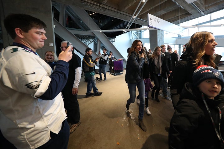 Gisele Bundchen walks through U.S. Bank Stadium before the Super Bowl on Sunday.