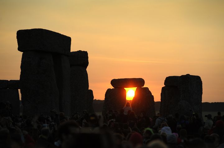 The sun rising behind the stones at Stonehenge 