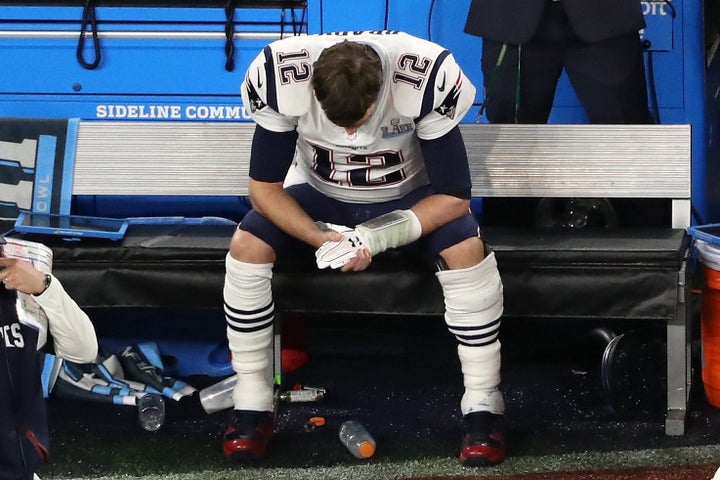 Patriots Quarterback Tom Brady sits on the bench after having the ball stripped by Brandon Graham of the Philadelphia Eagles.