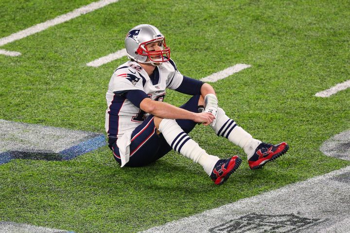 Tom Brady sits on the field after losing a fumble during the fourth quarter of Super Bowl LII.