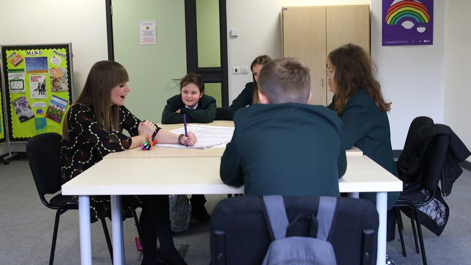 A group workshop discussing feelings about wellbeing and happiness.