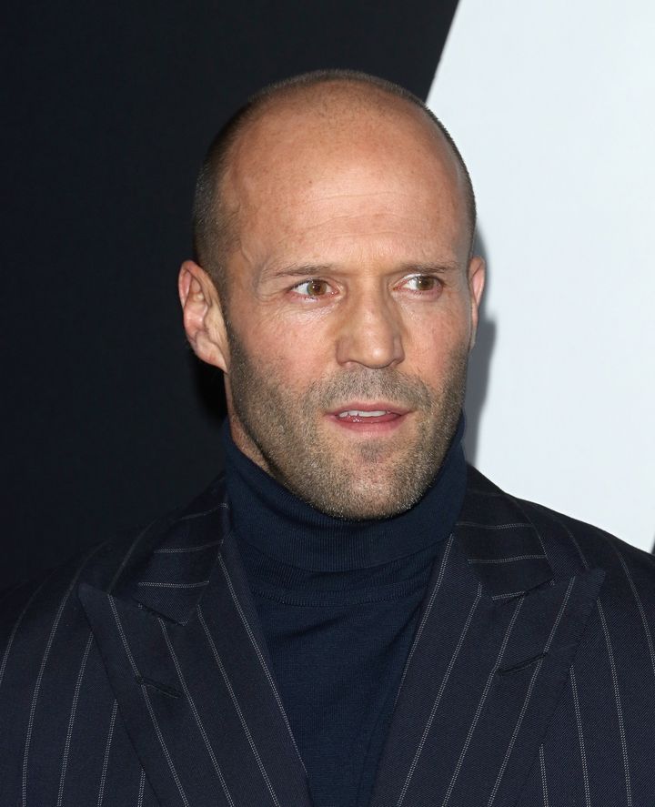 Jason Statham's short hair fades into his receding hairline.