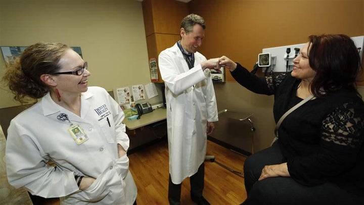A Colorado primary care doctor congratulates a patient after her checkup. The Trump administration is shifting to states the