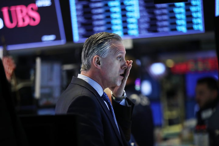 Traders work on the floor of the New York Stock Exchange on Feb. 6 during a wild day of market swings.