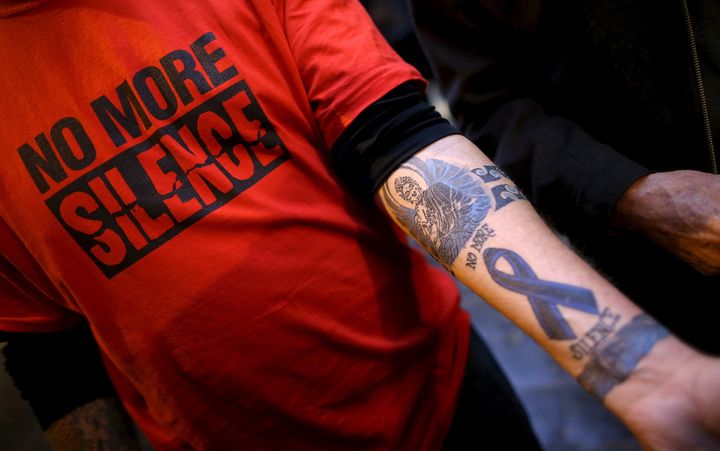 Paul Levely, a child sex abuse victim, wears a T-shirt that says "No more silence" and shows a tattoo in Rome in 2016 as Australian Cardinal George Pell answered questions via video from Australia's Royal Commission into Institutional Response to Child Sexual Abuse.