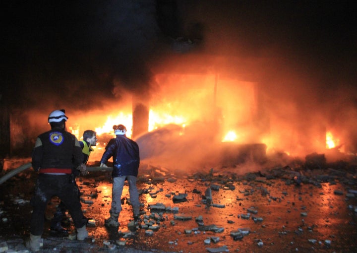 Civil defense members extinguish a fire that broke out after Russian airstrikes hit Idlib's Maarrat al-Numan district in Syri