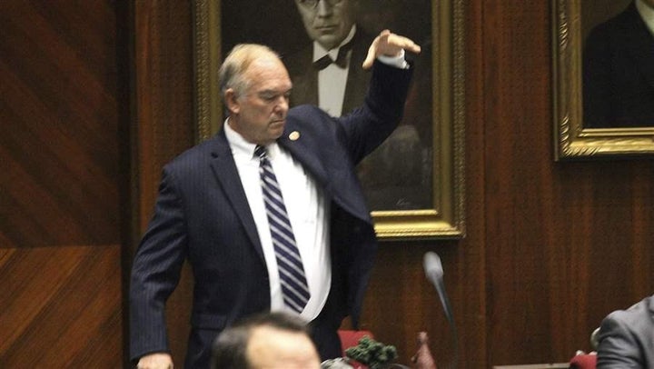 Arizona state Rep. Don Shooter, a Republican, drops his mic after voting no on a resolution that expelled him from the Legislature after he was accused of sexual harassment. Some states are considering proposals that would bar the use of taxpayer money to pay for sexual harassment settlements involving lawmakers.