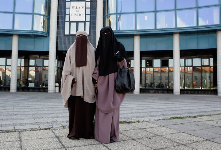 Hind Ahmas (right) stands with Kenza Drider as she leaves a court in Meaux, France, after facing fines for wearing a face veil on Sept. 22, 2011.