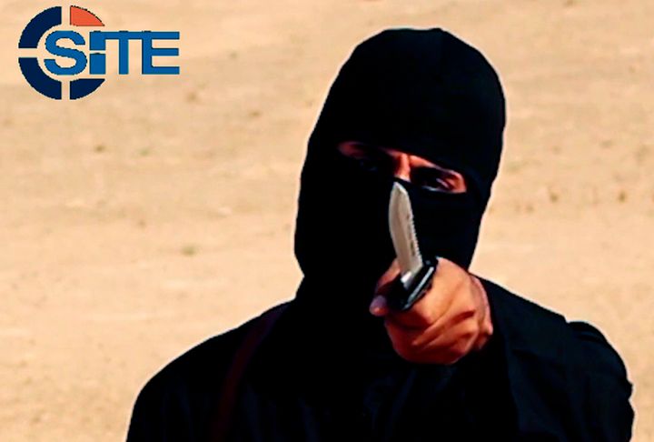 A masked, black-clad militant, identified as Mohammed Emwazi ("Jihadi John"), is pictured in 2014. Members of his terrorist cell, Alexanda Kotey and El Shafee Elsheikh, have reportedly been captured.