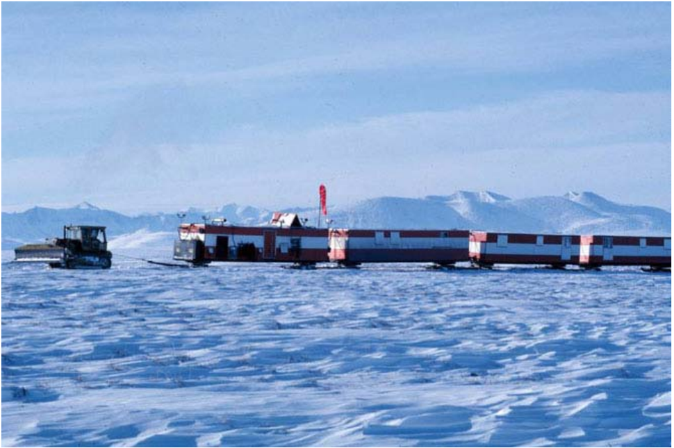 A tractor pulling ski-mounted camp trailers in the 1002 area of the Arctic National Wildlife Refuge during seismic explo