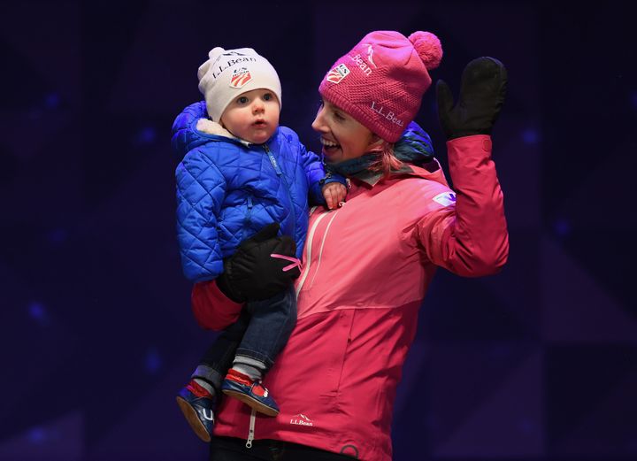 Kikkan Randall celebrates with her son, Breck, during a medal ceremony in Finland last year.