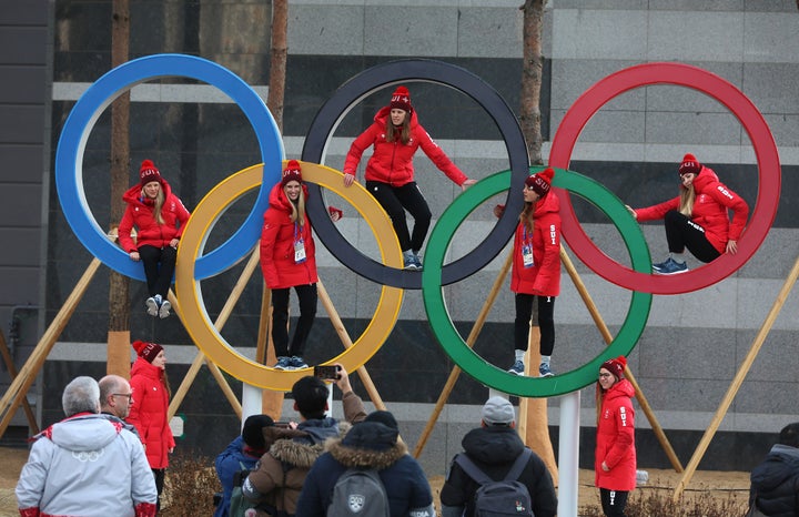 Swiss athletes pose inside the Olympic rings in Pyeongchang, South Korea, on Feb. 8, 2018.