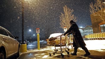 A customer pushes his cart through a parking lot outside a Home Depot Inc. store as snow falls in Evanston, Illinois, U.S., on Thursday, Feb. 8, 2018. The biggest snowstorm of the season is heading towards Chicago. The dump will start late Thursday and continue through the next day, bringing 8 to 10 inches (20 to 25 centimeters). Photographer: Jim Young/Bloomberg via Getty Images