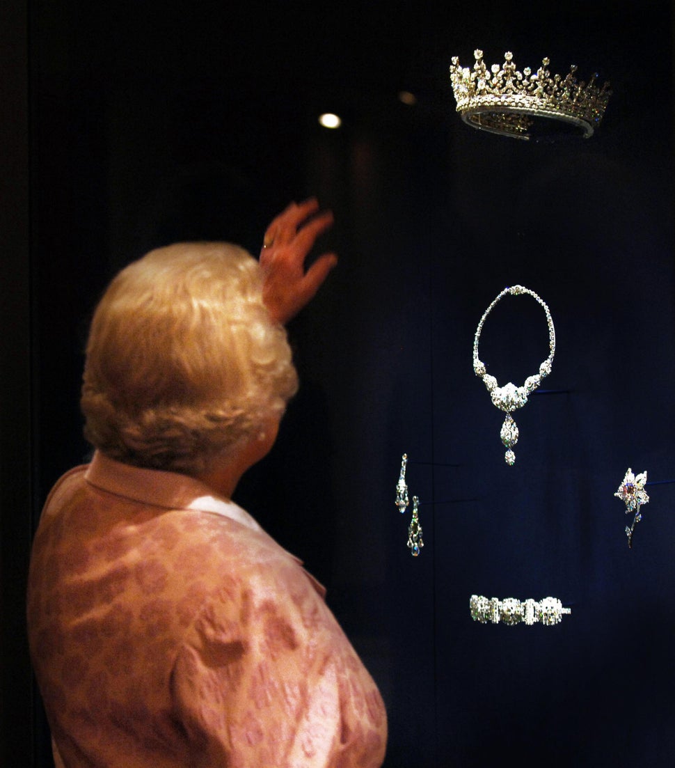 Queen Elizabeth II shown in 2007 looking at the Queen Mary Diamond Tiara given to her as a wedding present by her grandmother Queen Mary, who herself received it as a wedding gift