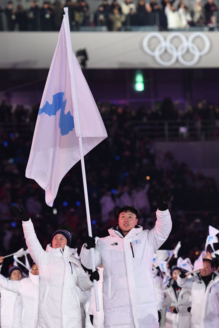 Unified Korea's flag bearers lead the delegation parade during the opening ceremony of the 2018 Winter Olympic Games on February 9, 2018.